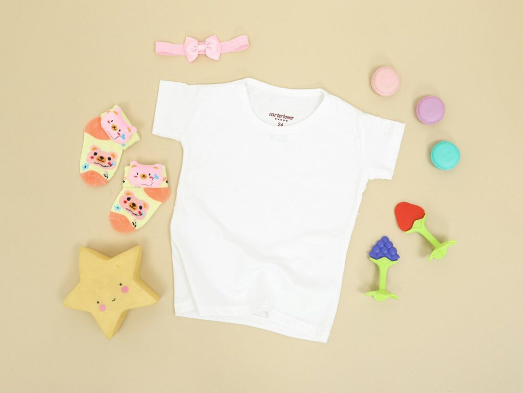 babys white onesie and pink and white bear print onesie